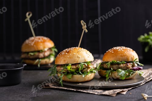 Preview: Three Delicious Burgers Served on Plate with Greens