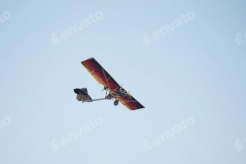 Preview: Plane flying high up in the cloudless sky at daytime. Male pilot