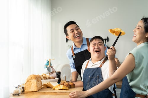 Preview: Asian happy family, mature parents baking bakery with son in kitchen.