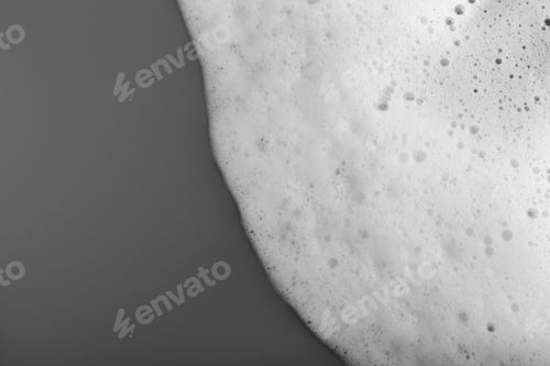 Preview: White foam with bubbles on grey background, top view. Space for text