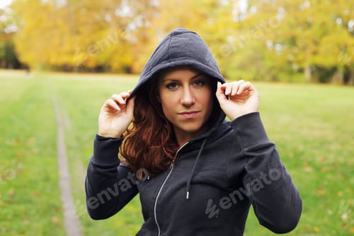 Preview: Confident female athlete in hoodie