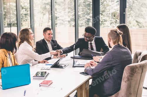 Preview: Business people shaking hands, finishing up meeting. Six young cheerful business people sitting