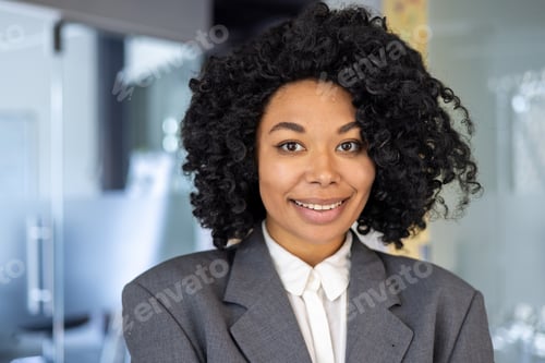 Preview: Beautiful african american woman close up inside office, businesswoman in business suit smiling and