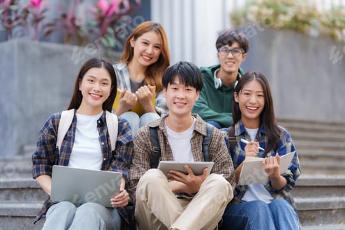 Preview: Group Of Young Asian Students Collaborating Outdoors at University.