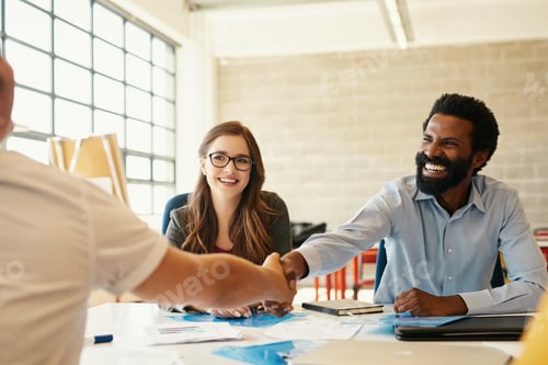 Preview: Shot of creative employees shaking hands in a modern office