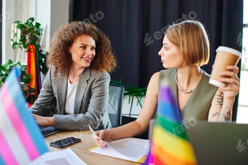 Preview: Dynamic coworkers collaborate in a vibrant office celebrating LGBTQ diversity and inclusion