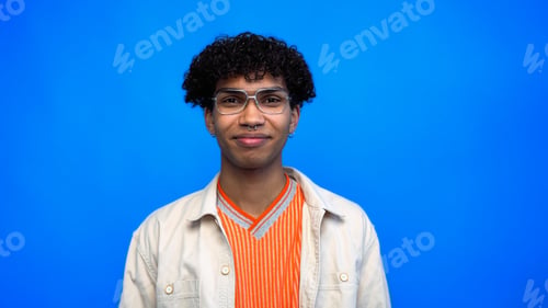 Preview: Stylish african american man in eyeglasses looking at camera isolated on blue