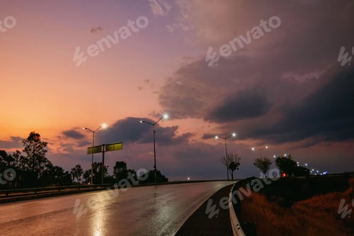 Preview: Road illuminated by lamps in beautiful sunset