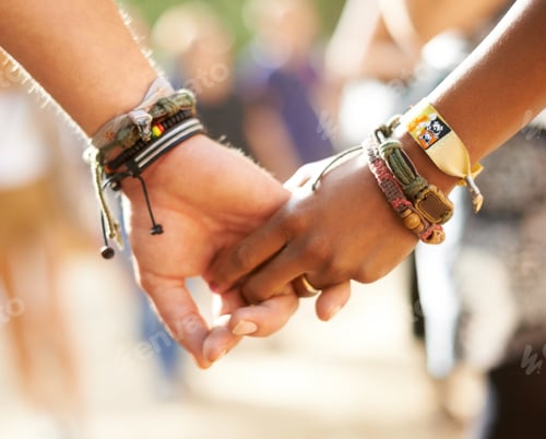 Preview: Cross-cultural friendship. Cropped closeup view of a multi-ethnic couple holding hands.