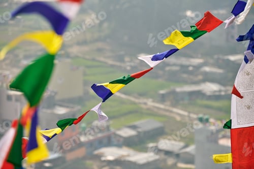Preview: Colorful Tibetan prayer flags on blurred Kathmandu cityscape background