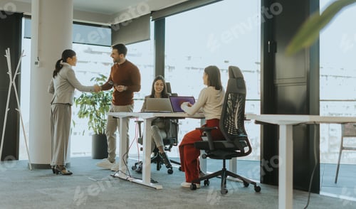Preview: Business professionals collaborate in a modern office setting during a productive meeting