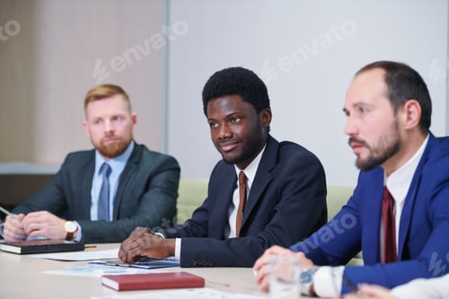 Preview: African businessman and his Caucasian colleagues or partners