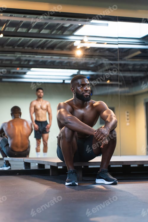 Preview: Black athlete resting during training with his teammate