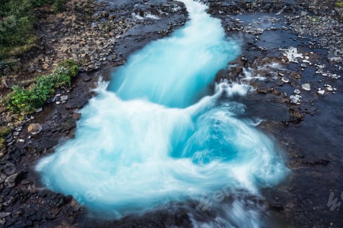 Preview: Turquoise Bruarfoss waterfall flowing rapidly over wilderness