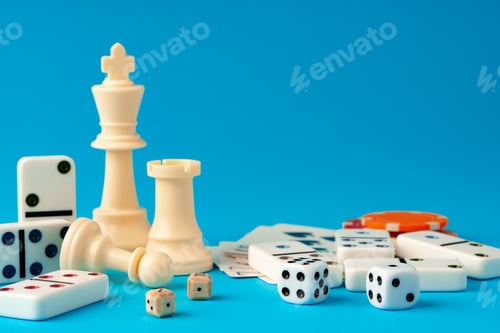 Preview: Items for playing chess, poker and domino on blue background studio shot