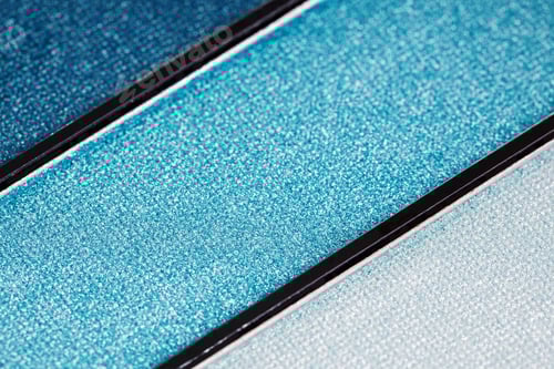 Preview: Close up of a palette of eyeshadows in blue tones.