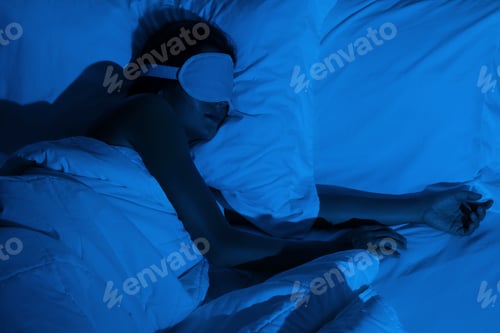 Preview: Woman sleeping with a sleep mask on her eyes