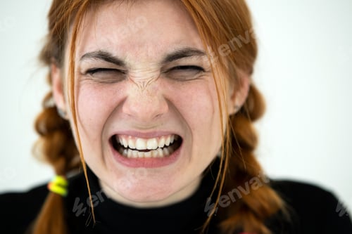 Preview: Close up portrait of angry redhead teenage girl.