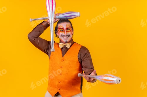 Preview: Cheerful circus performer skillfully juggling a number of clubs isolated on yellow background