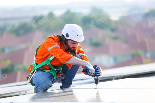 Preview: Workers Installing Solar Panels on warehouse Roof.