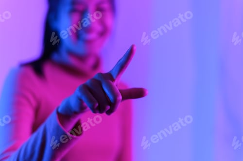 Preview: Selective focus of an Asian girl's finger pointing to a side