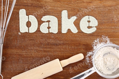 Preview: Stencil word "bake" made with flour on wooden table