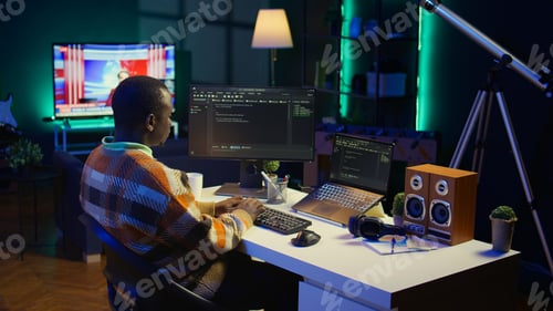 Preview: African american self employed developer in home office coding on his computer