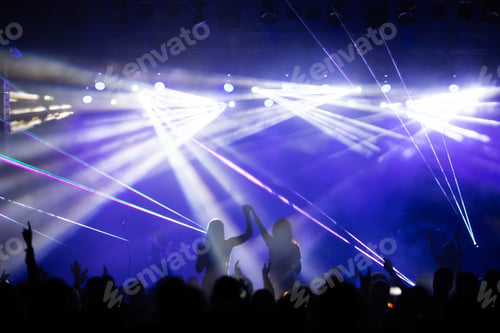 Preview: Crowd at concert and colorful stage lights.