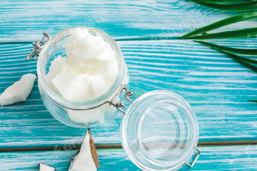 Preview: Coconut butter on wooden background. Organic healthy food concept