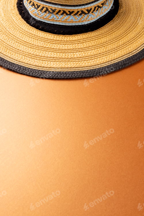 Preview: Vertical image of straw hat on yellow surface