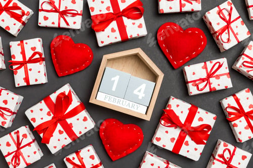 Preview: Composition of wooden calendar, holiday white gift boxes and red textile hearts