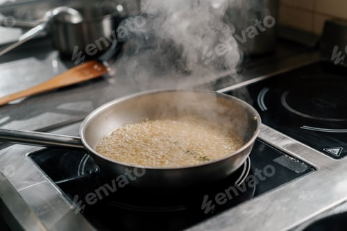 Preview: Professional kitchen in the hotel restaurant close-up of chef preparing risotto on the stove