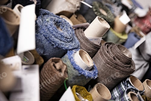 Preview: Closeup of colorful fabric rolls in a tailor's workshop