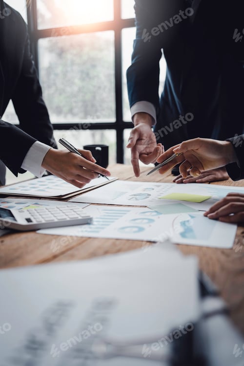 Preview: Businessmen meeting to plan, analyze, graph and chart business growth. to plan for new business
