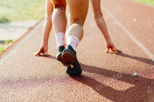 Preview: Athlete readying for sprint race on running track