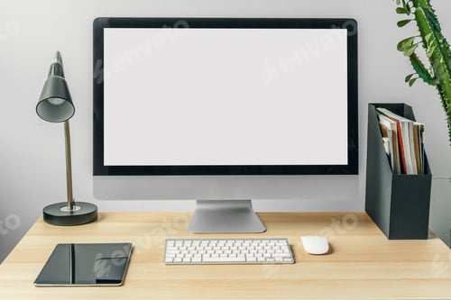 Preview: Computer monitor with mockup white screen on office table with supplies