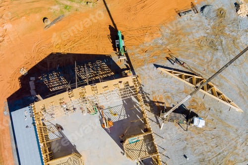Preview: The crane holds a roof truss wood for the roof of the house