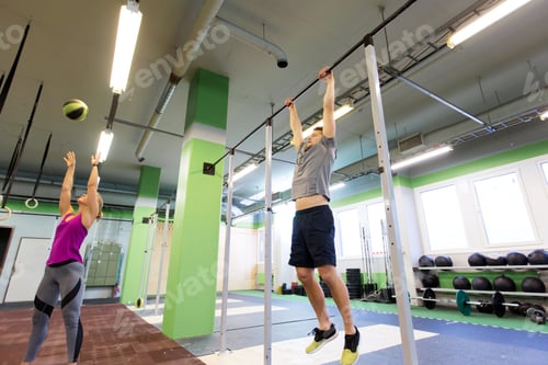 Preview: woman and man exercising in gym