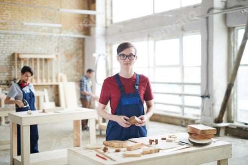 Preview: Young carpenter working with wood