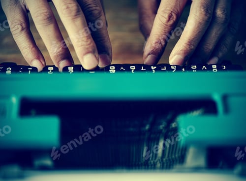 Preview: Closeup Of A Man Typing In An Old Blue Typewriter, With A Filter Effect