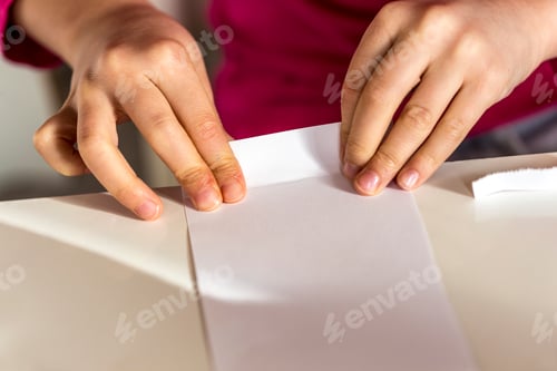 Preview: Girl folding piece of paper