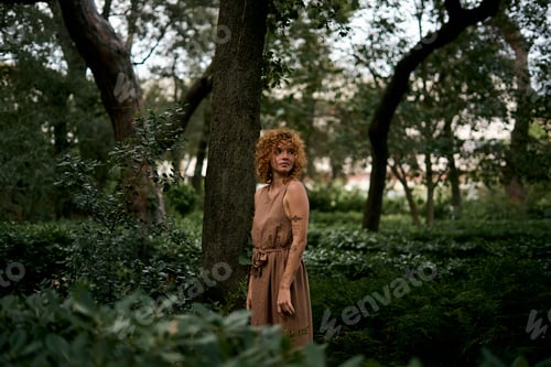 Preview: Woman with vitiligo in forest looking away