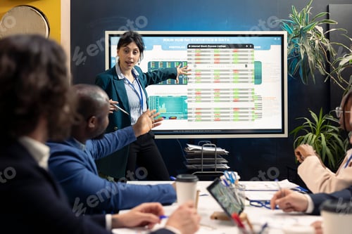 Preview: Business affiliates examining current budgeting plans on interactive board