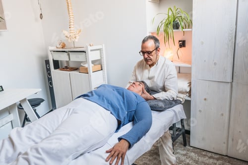 Preview: therapy in holistic clinic with practitioner focusing on head support and patient relaxation.