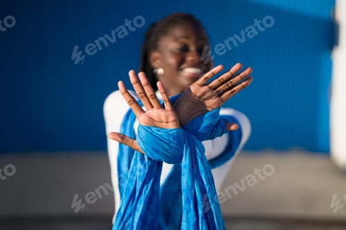 Preview: Young dancer showing her hands tied with blue cloth