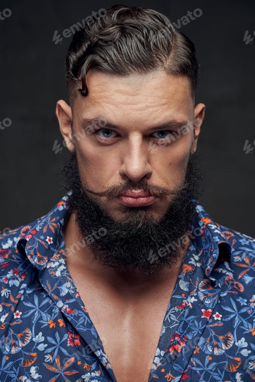 Preview: Mature guy with styled haircut and beard posing in studio