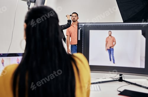 Preview: Woman, photographer and studio with man, makeup and camera for vision, fashion and magazine. Photog