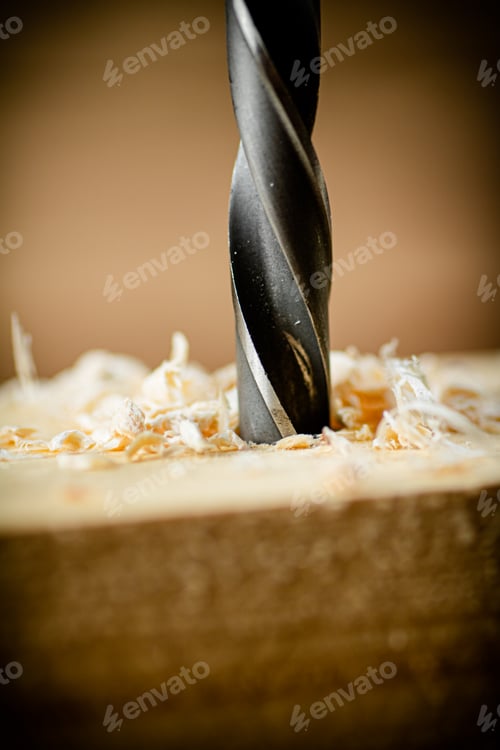 Preview: Piece of wood is drilled with shavings.