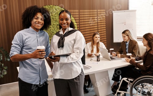 Preview: Business team working together with charts and technology in modern office environment