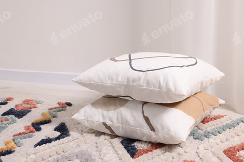 Preview: Stacked soft pillows on floor in room